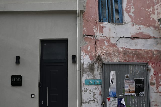Narrow street where traditional architecture meets a freshly painted rental property