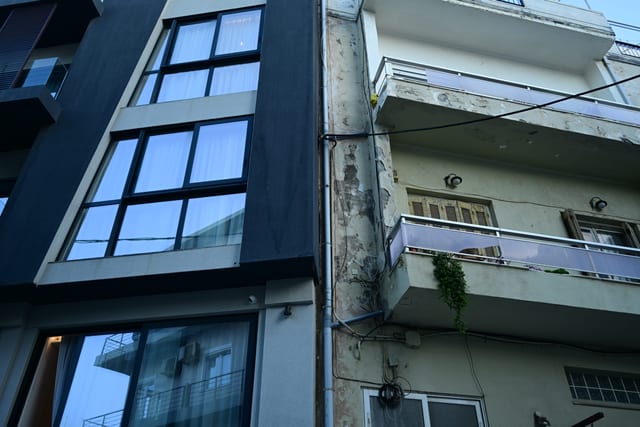Construction debris piled outside a building being converted into tourist accommodation