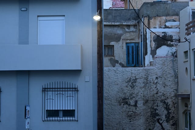 View down a narrow alley with contrasting old and new building surfaces