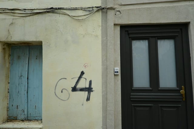 Narrow passage between old stone building and new rental development